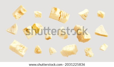 Broken pieces of classic cream cheese of various shapes isolated on gray background. Food, delicious cheese, elements for your design. Cheese collection