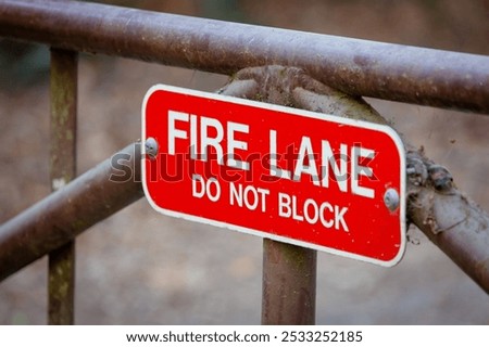 Similar – Foto Bild Dreckiges Feuerwehrzufahrt-Schild und Winterdienst-Schild vor einem öffentlichen Gebäude