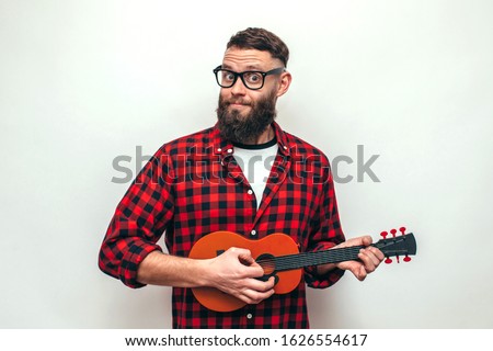 Similar – Image, Stock Photo Cheerful man playing ukulele guitar