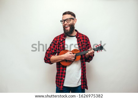 Similar – Image, Stock Photo Cheerful man playing ukulele guitar