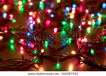 bright colored garlands bulb shines in the dark background