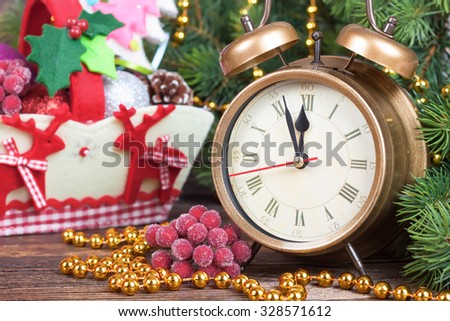 New Year clock and fir branches with Decorative basket with deer. Filtered in retro style