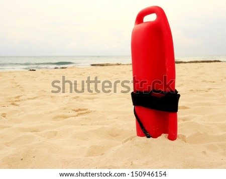 Typical red plastic lifeguard tube on a sandy beach