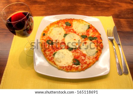 Mozzarella pizza and a glass of red wine