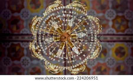 Beautiful mosaic arabesque design on ceiling of a mosque. Mosque ornaments on the walls and chandelier composition