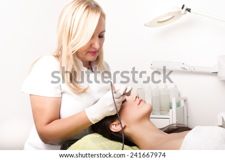 Professional cosmetician tattooist making permanent make up.Permanent make-up (tattoo).Cosmetologist applying permanent make-up on eyebrows.Cosmetologist making permanent make up in beauty salon