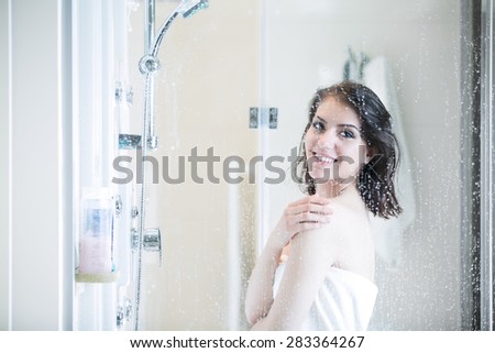 Beautiful sexy woman in towel after shower. Relaxation of young woman taking shower