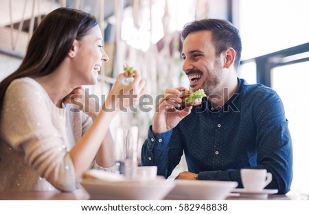 https://image.shutterstock.com/display_pic_with_logo/163641428/582948838/stock-photo-happy-loving-couple-enjoying-breakfast-in-a-cafe-love-dating-food-lifestyle-582948838.jpg