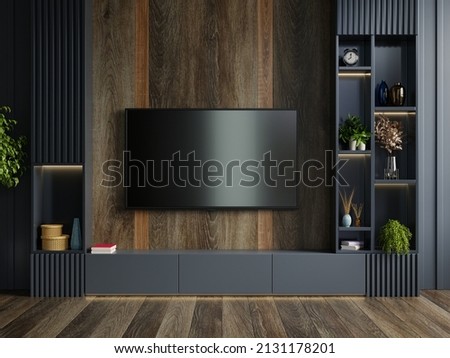 Wooden wall mounted tv in modern living room with decoration on dark wall background.3D rendering 商業照片 © 