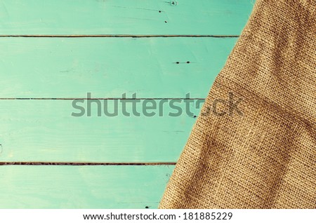 Burlap texture on wooden table background. Table with copy space. Vintage filter.