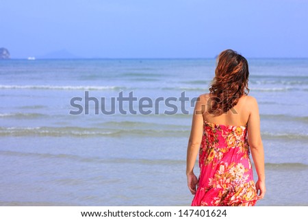 Woman turns back looking to the sea
