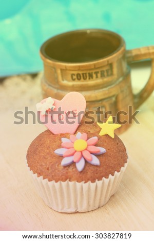 Chocolate muffin decorated with sugarpaste having  LOVE letter on heart