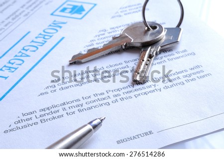 mortgage contract for signature with detail of keys to buying a home closeup