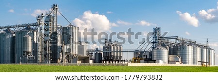 silver silos on agro-processing and manufacturing plant for processing drying cleaning and storage of agricultural products, flour, cereals and grain. Granary elevator.  Photo stock © 