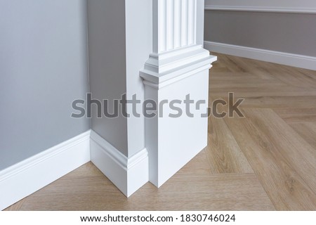 Detail of corner flooring with intricate crown molding. 