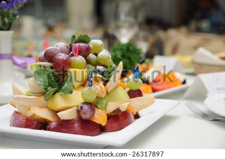 Fruit salad (grape, apple, pear, orange, mix) on a plate in fine restaurant