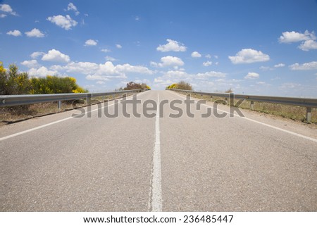 landscape straight rural grey lonely road in countryside of Spain Europe
