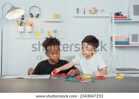 Similar – Image, Stock Photo Two children playing with their mobile on the beach