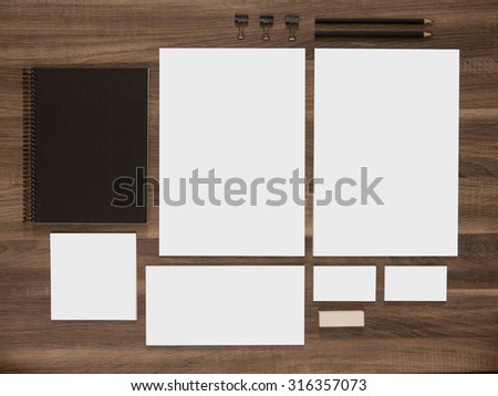 Branding mockup collection for corporate identity presentation. Blank business cards with documents, envelopes and black notepads on wood desk.