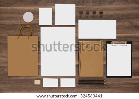 Mockup business template with shopping bag, notepads and envelopes. Natural wooden background.