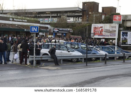 HAYWARDS HEATH,UK - DECEMBER 24th: People waiting / delayed at train station after the bad storm on December 24th, 2013. The storm caused many delays, stopping people getting home for Xmas.
