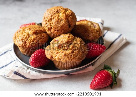 Similar – Image, Stock Photo Eating a strawberry muffin. Woman hands holding a muffin. Fruit dessert