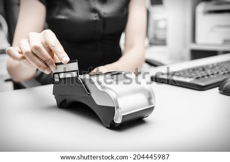 Human hand holding plastic card in payment
