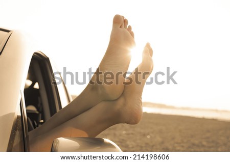 Travel vacation freedom beach vintage concept. Female legs out of car window.