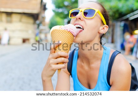Girl eating an ice cream. Focus on the ice cream