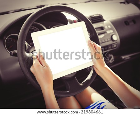Woman in the car with tablet pc. Vintage photo.