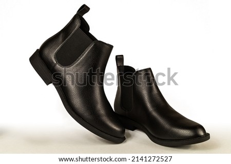 Close up of a women's black leather chelsea boots on white background. Fashion advertising shoes photos. ストックフォト © 
