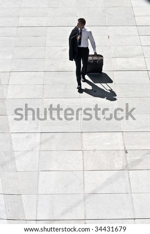 Young Corporate Man With Luggage Walking On Pavement