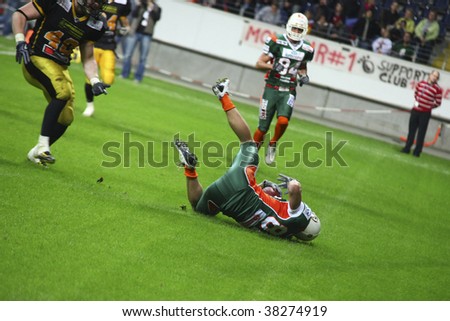 FRANKFURT - OCT 3: Wide Receiver of Kiel Baltic Hurricanes Marico Gregersen catches the ball and falls to the ground at German Bowl XXXI on Oct 3, 2009 in Frankfurt, Germany.