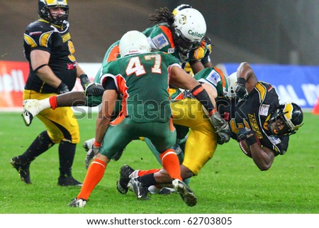 FRANKFURT - OCTOBER 09: Talib Wise of Berlin Adlers was stopped by Kiel Baltic Hurricane players during the German Bowl XXXII October 09, 2010 in Frankfurt, Germany.