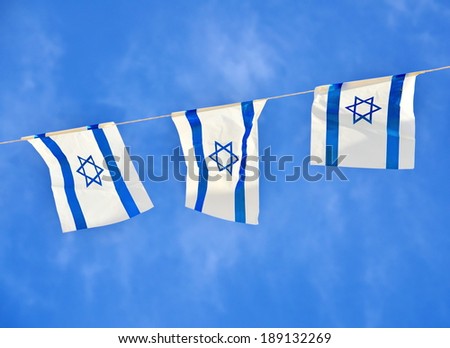 Israel flags in a chain in white and blue showing the Star of David hanging proudly for Israel\'s Independence Day (Yom Haatzmaut)