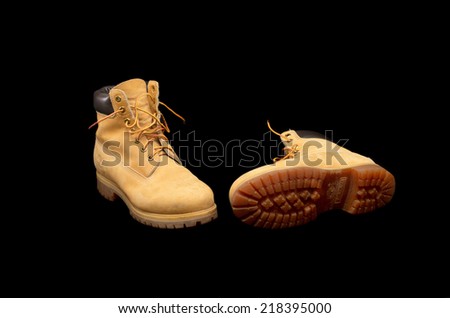 TEL AVIV, SEPT 20, 2014: Authentic pair of 8 inch Timberland Yellow Work Boots isolated on black showing the sole (illustrative editorial)