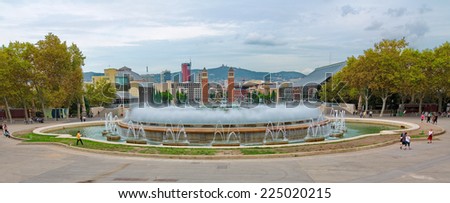 BARCELONA - OCT. 14, 2014 - The Magic Fountain (Font magica) in front of the The Venetian Towers and Placa d\'Espanya (Plaza de Espana) in Montjuic, Barcelona, Spain