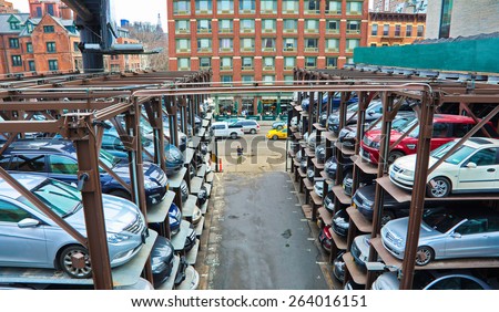 NEW YORK - MARCH 11, 2015: People and cars in a busy multi-level parking garage in mid-town Manhattan, New York City, USA