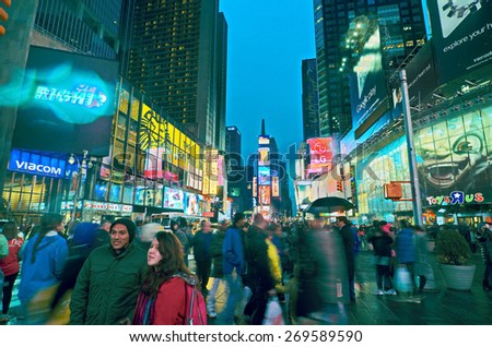 NEW YORK, MARCH 14, 2015: Times Square at night - HDR featuring busy Broadway with animated signs for the Lion King and other shows.  Theater District is a symbol of New York and the United States.