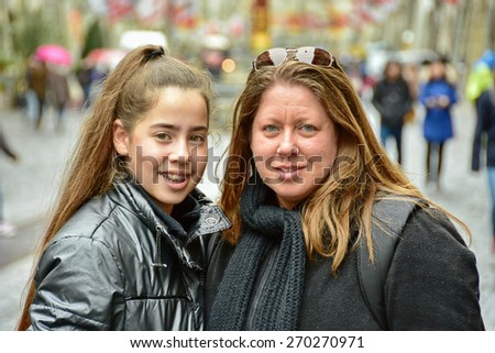 Teenage girl with pink braces on her teeth in touring Bern, Switzerland, Europe with her mother