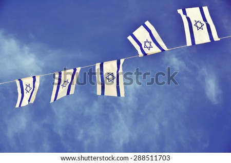 Israel flags in a chain in white and blue showing the Star of David hanging proudly for Israel's Independence Day (Yom Haatzmaut)