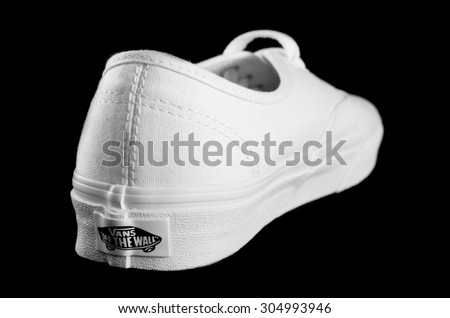 NEW YORK - AUGUST 8, 2015: White Vans (Off the Wall) sneaker isolated on black