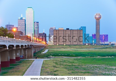 Downtown Dallas, Texas skyline at the blue hour including famous towers, the Commerce Street Bridge, and Trinity Park
