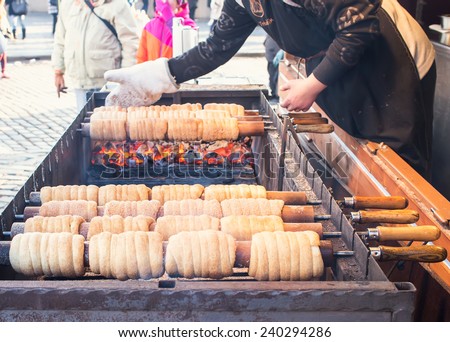 Prague, Czech Republic,  25.12.2014: Czech national winter street food called trdlo (trdelnik) is being cooked in the square of Prague during Christmas time