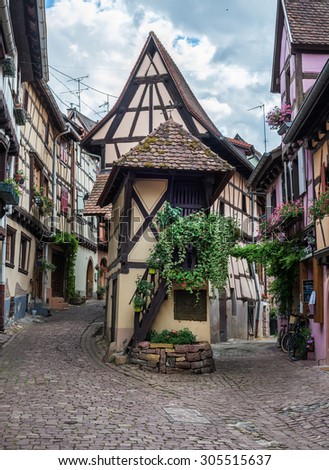 EGUISHEIM, FRANCE - JUNE, 20: Famous oldest timbered traditional french house in the street of Eguisheim, Alsace region, France, June, 20, 2015.