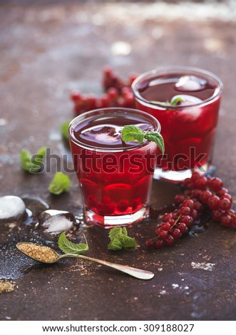 Red berry lemonade with ice and mint on grunge vintage rusty metal background, copy space