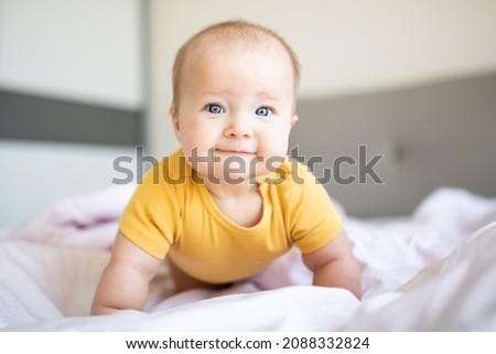 Similar – Image, Stock Photo Caucasian blonde baby seven months old lying on bed at home. Kid wearing cute clothing yellow color