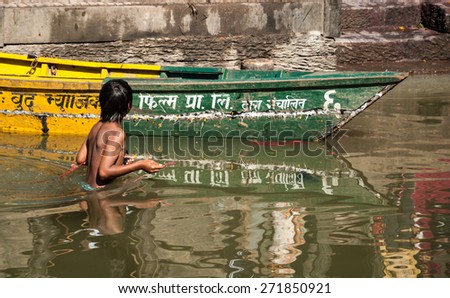PASHUPATINATH TEMPLE, KATHMANDU, NEPAL-OCTOBER 18, 2008: Nepali  people, young and old, arrive to take a bath or wash cloths in Bagmati river. It is considered a holy river by Hindus and Budhists.