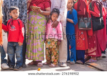 KATHMANDU, NEPAL-OCTOBER 18, 2008: Nepali Budhists,old and young, men, women and children stand in a long line to make offerings to Budha on Swaymbhunath Temples hill,