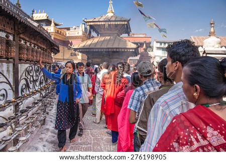 KATHMANDU, NEPAL-OCTOBER 18, 2008: Nepali Budhists,old and young, men, women and children stand in a long line to make offerings to Budha on Swaymbhunath Temples hill,